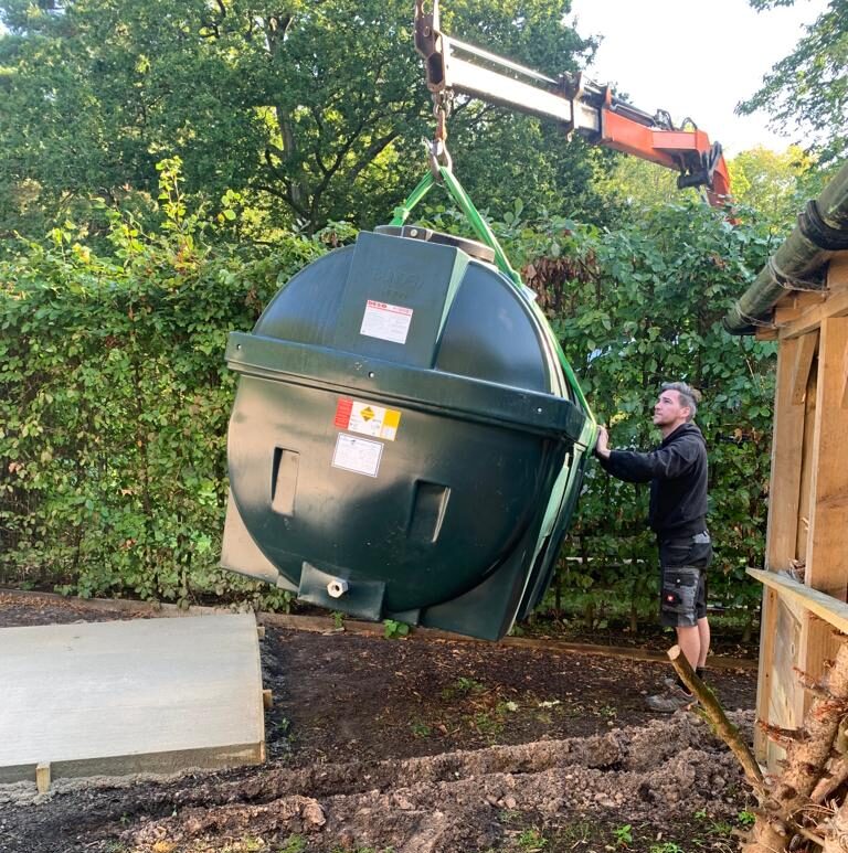 Green tank being lifted
